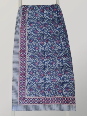 Berry Denim cotton sarong hanging full length, showing its denim blue print with tiny pink florals