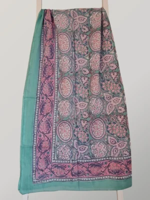 Boho Bubblegum cotton sarong hanging full length, showing its turquoise and dusty pink paisley print